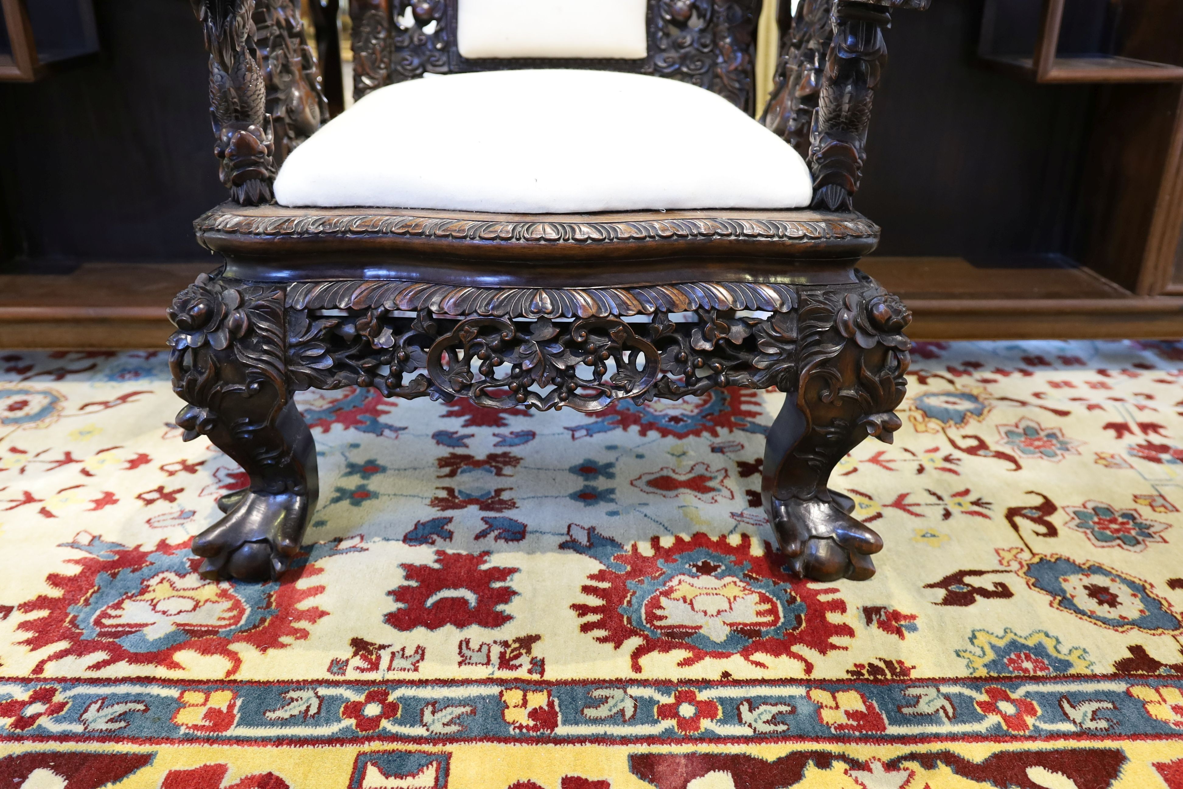 A good Chinese hardwood ‘dragon’ throne armchair, c.1900, 114.5cm high, 68cm wide at the arms